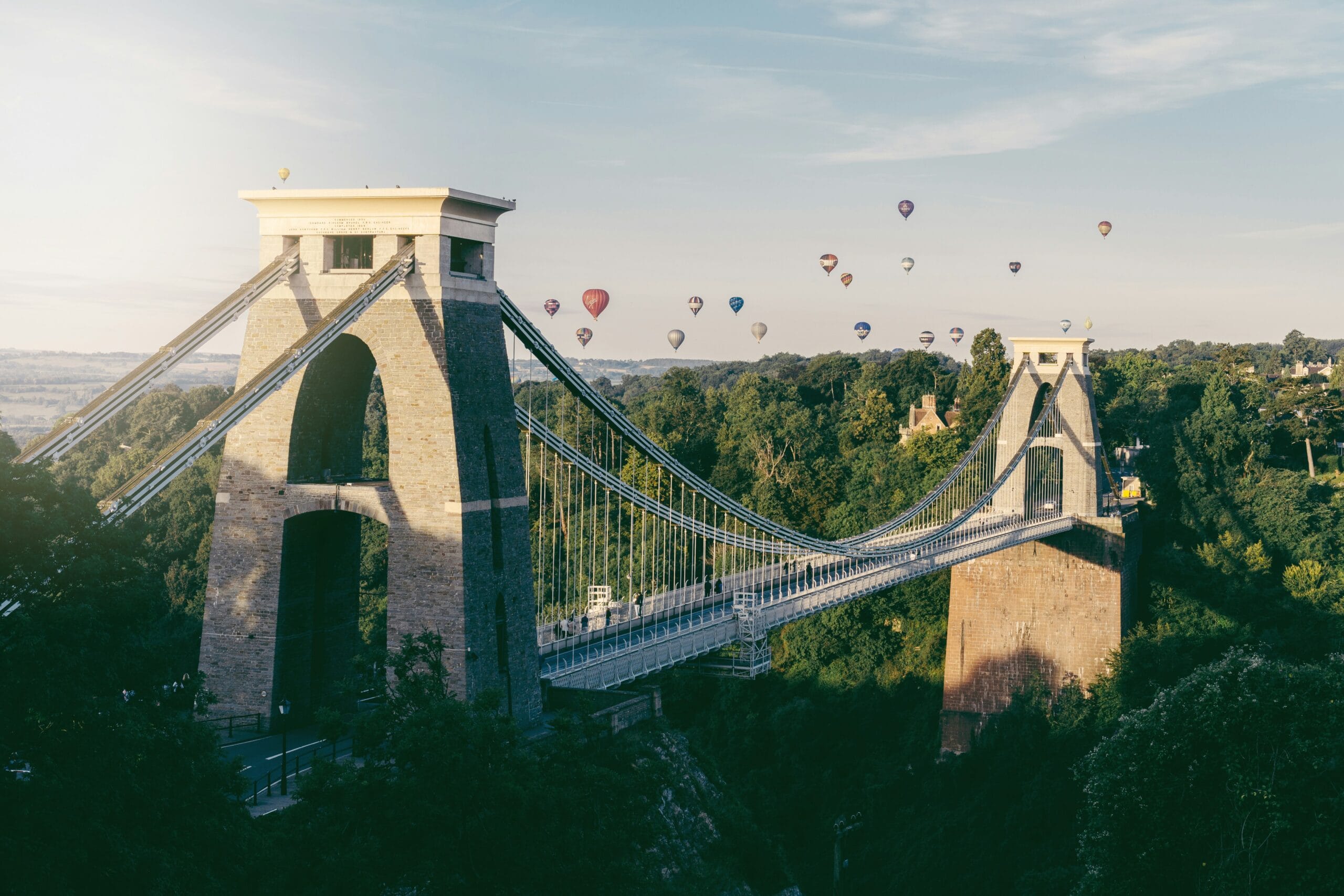 Clifton Suspension Bridge with a bridge and hot air balloons in the sky